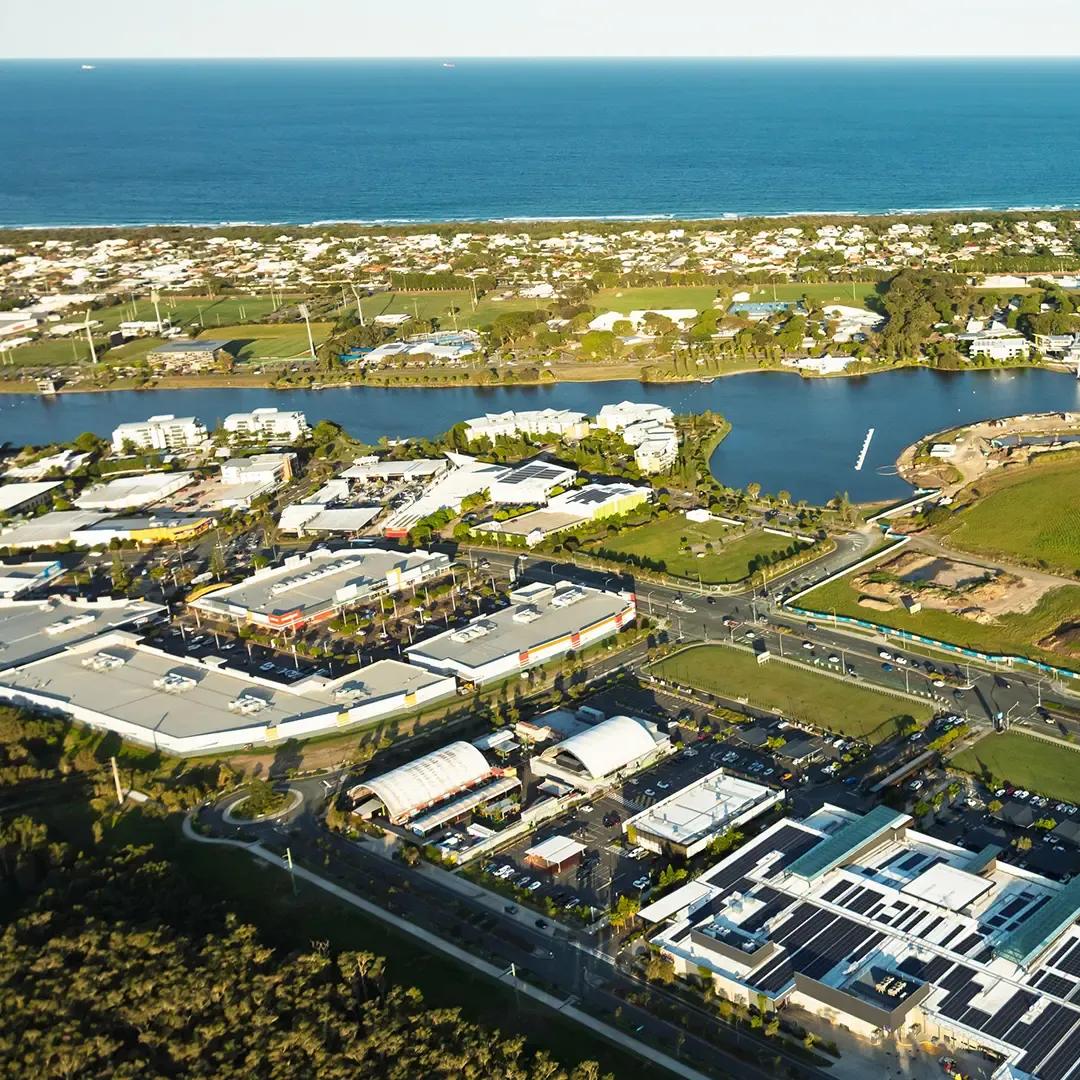Birtinya aerial view of waterways, coastal beach and growing housing community