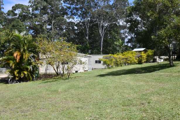 VACANT LAND PARCEL WITH STORAGE SHEDS.