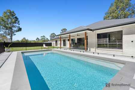 CUSTOM DESIGNED HOME WITH SPARKLING INGROUND POOL