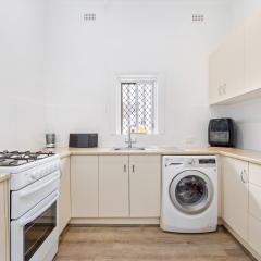 Laundry with second gas stove and abundance of cabinets for storage and bench space