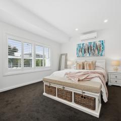 Main bedroom with plantation shutters, split system air conditioner and carpet