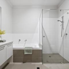 Spacious bathroom with bath and shower recess