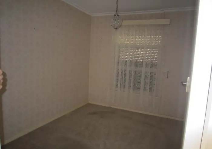 Bedroom 2 with manual roller shutter.