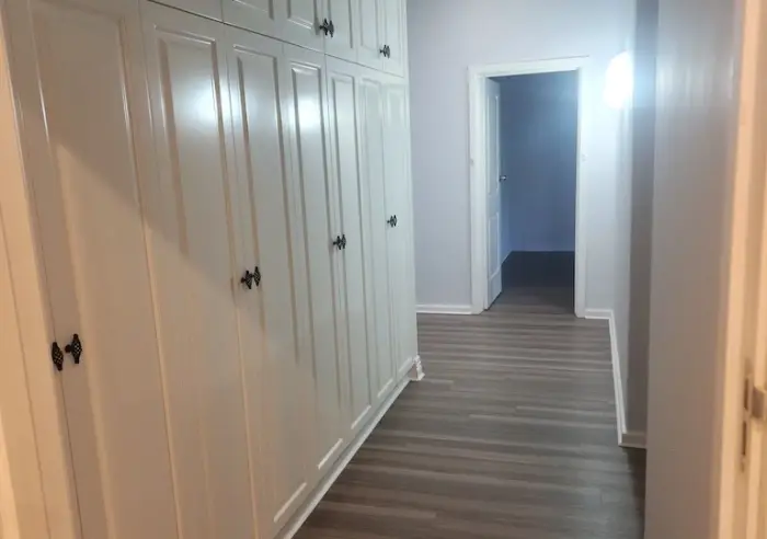 Hallway with floor to ceiling built in cupboards