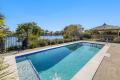 Stylish Single-Level Waterfront Living on 700m² with Pool