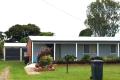 3 Bedroom low set home on flood free property across from Parkland with 4 bay shed