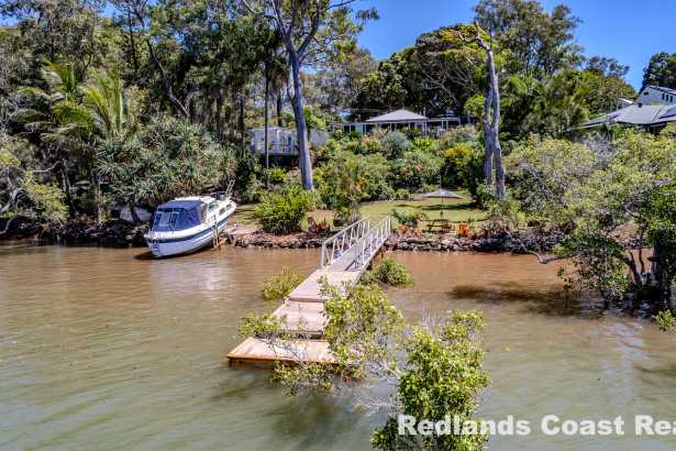 Waterfront Paradise with Deep Water Access on Nearly Half an Acre