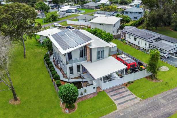 A home that keeps on giving: Water views, home theatre movie nights and a car enthusiast’s dream workshop