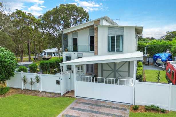 A home that keeps on giving: Water views, home theatre movie nights and a car enthusiast’s dream workshop