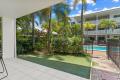 Ground floor Unit with Large Courtyard and Beautiful Views of Tropical Gardens and Pool