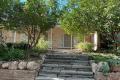 EXECUTIVE HOME SET AMONGST TRANQUIL GARDENS WITH LARGE SOLAR SYSTEM & GARDENER